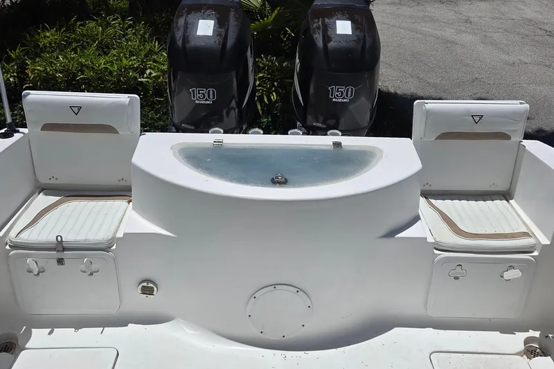 Slide: The Image of 2009 Sea Fox 256 Walk Around boat with dual Suzuki 150 engines and seating area. - 14
