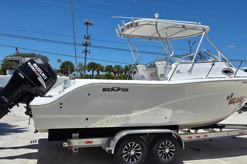 Slide: The Image of 2009 Sea Fox 256 Walk Around boat on trailer with Suzuki outboard motor. - 2