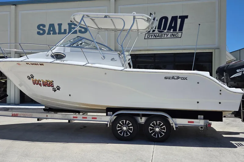 Slide: The Image of 2009 Sea Fox 256 Walk Around boat on trailer outside sales building. - 3