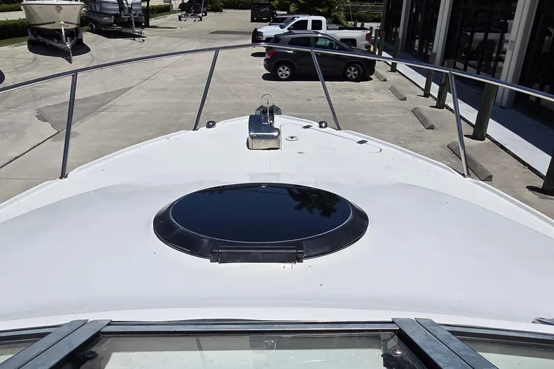 Slide: The Image of 2009 Sea Fox 256 Walk Around boat deck with hatch, parked in marina. - 7