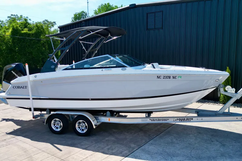Slide: The Image of 2023 Cobalt R4 Outboard boat on trailer, parked outdoors. - 13
