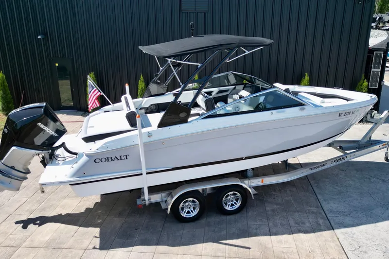 Slide: The Image of 2023 Cobalt R4 Outboard boat on trailer, featuring sleek design and Mercury engine. - 14