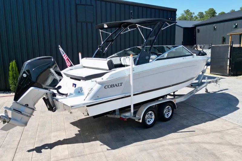 Slide: The Image of 2023 Cobalt R4 Outboard boat on trailer, sleek design, parked outdoors. - 3