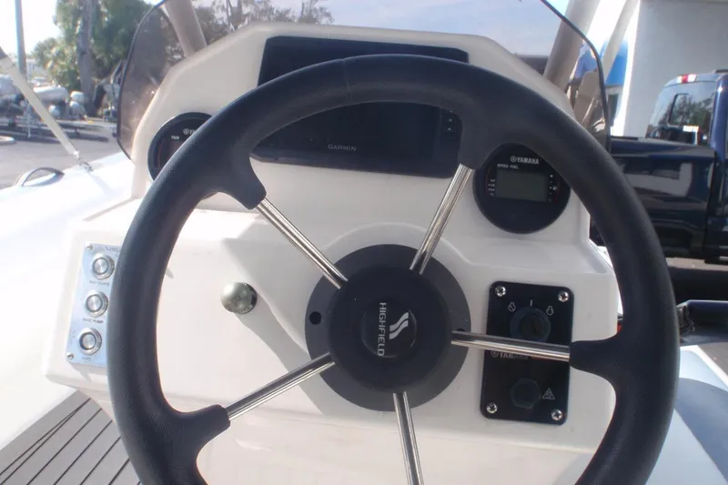Slide: The Image of Steering wheel of 2021 Highfield Sport 460 boat with control panel and gauges. - 2