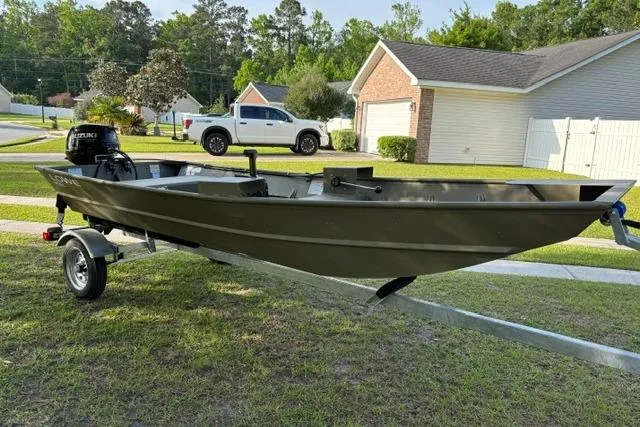 Slide: The Image of 2026 Lowe L1436 Jon boat on trailer in suburban neighborhood. - 5