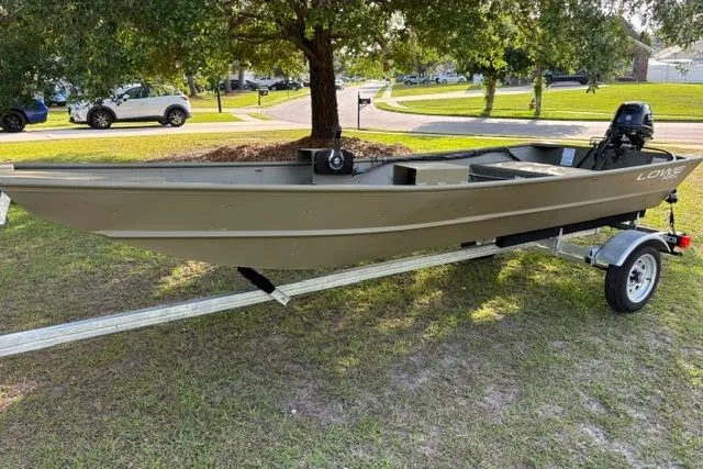 Slide: The Image of 2026 Lowe L1436 Jon boat on trailer, parked on grass under a tree. - 6