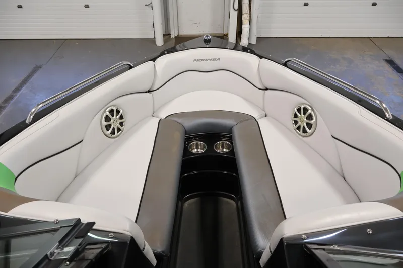 Slide: The Image of Interior of a 2011 Moomba Mobius LSV boat with white seating and speakers. - 10