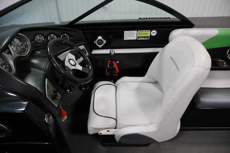 Slide: The Image of 2011 Moomba Mobius LSV interior with steering wheel, gauges, and white captain's seat. - 14
