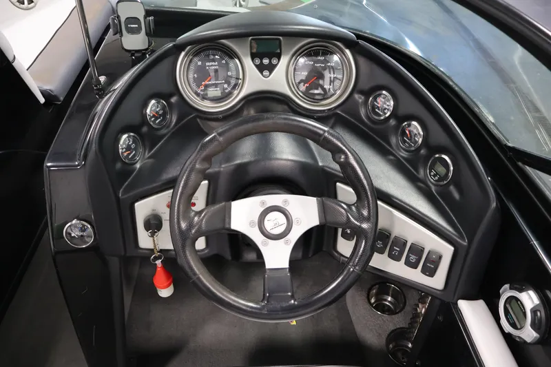 Slide: The Image of 2011 Moomba Mobius LSV dashboard with steering wheel and gauges. - 15
