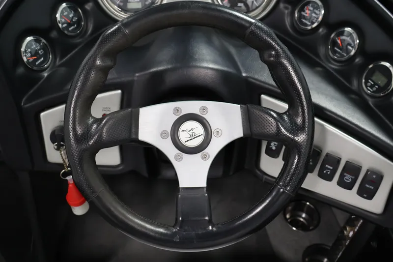 Slide: The Image of Steering wheel of a 2011 Moomba Mobius LSV boat with dashboard controls. - 16