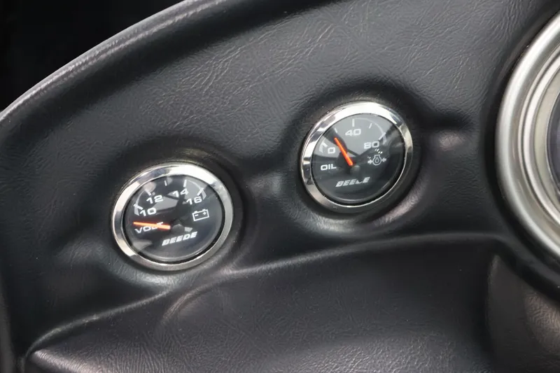 Slide: The Image of Dashboard gauges of a 2011 Moomba Mobius LSV boat, showing voltage and oil pressure. - 18