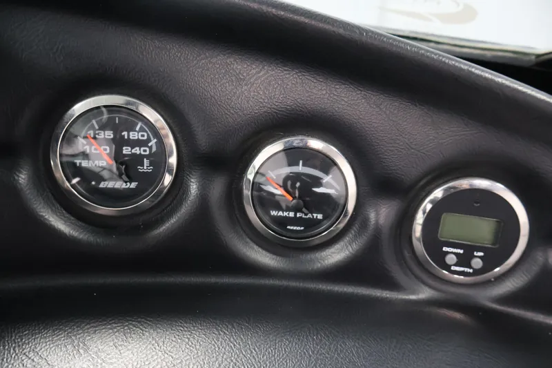 Slide: The Image of Dashboard gauges of a 2011 Moomba Mobius LSV boat, showing temperature and wake plate indicators. - 19