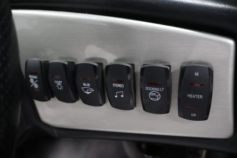 Slide: The Image of Control panel switches on a 2011 Moomba Mobius LSV boat dashboard. - 22