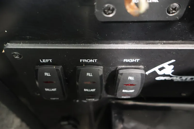 Slide: The Image of Control panel of a 2011 Moomba Mobius LSV boat with ballast fill switches. - 24