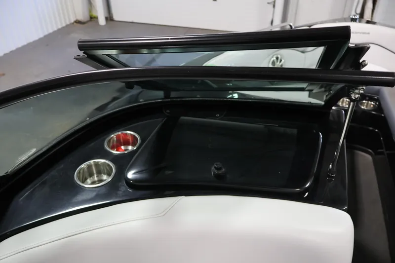 Slide: The Image of 2011 Moomba Mobius LSV boat interior with cup holders and windshield detail. - 26