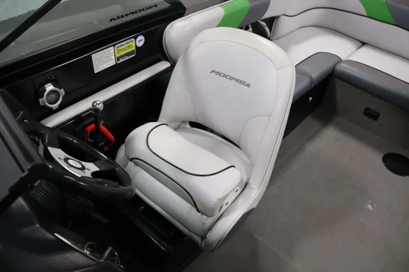 Slide: The Image of 2011 Moomba Mobius LSV boat interior with steering wheel and seating. - 29