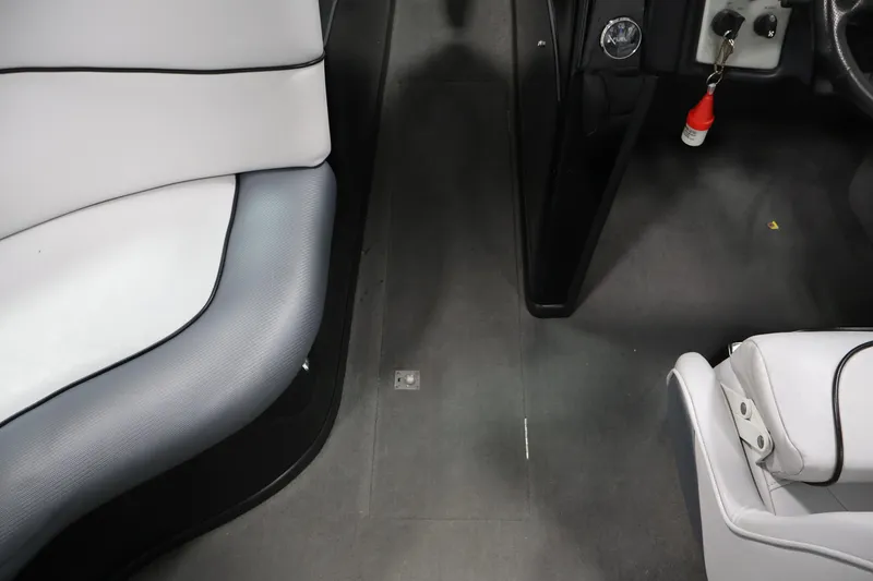 Slide: The Image of Interior of a 2011 Moomba Mobius LSV boat, featuring white and gray seating. - 30