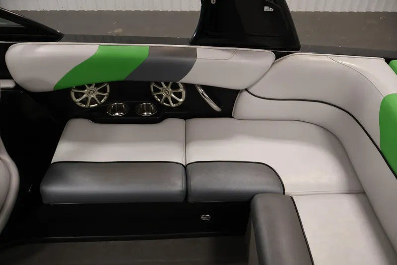 Slide: The Image of 2011 Moomba Mobius LSV interior with stylish green, gray, and white seating and built-in speakers. - 35