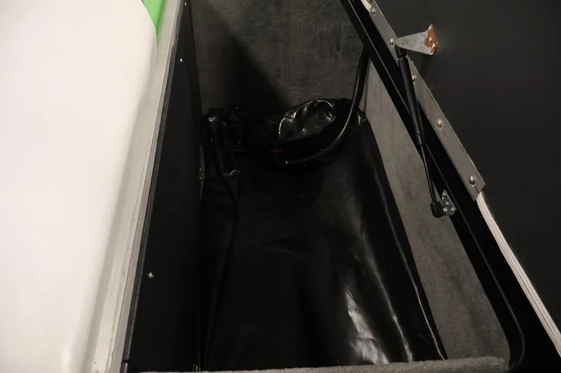 Slide: The Image of Open storage compartment in a 2011 Moomba Mobius LSV boat, featuring hydraulic lift support. - 38