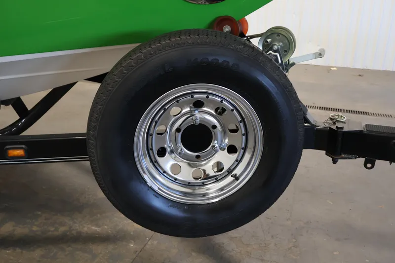 Slide: The Image of 2011 Moomba Mobius LSV trailer wheel with chrome rim and black tire. - 46