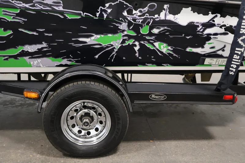 Slide: The Image of 2011 Moomba Mobius LSV trailer with vibrant black and green graphics. - 48