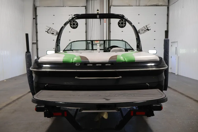 Slide: The Image of 2011 Moomba Mobius LSV boat in a garage, rear view with speakers and swim platform. - 5