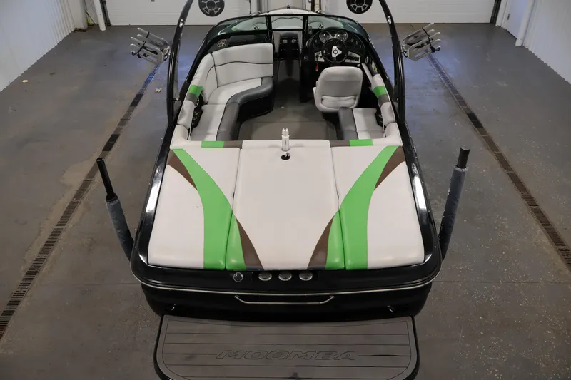 Slide: The Image of 2011 Moomba Mobius LSV boat interior with green and brown accents in a garage setting. - 9