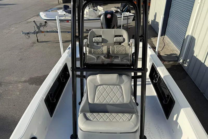 Slide: The Image of 2026 Blazer Bay PURE BAY 2200 boat interior with cushioned seating and steering console. - 12