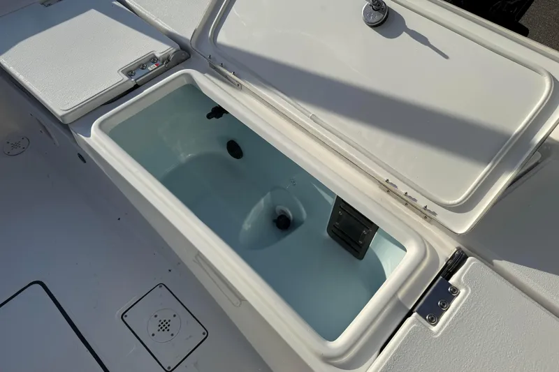 Slide: The Image of 2026 Blazer Bay PURE BAY 2200 boat storage compartment with open lid, showcasing interior features. - 27