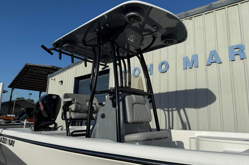Slide: The Image of 2026 Blazer Bay PURE BAY 2200 boat with T-top and seating, docked at marina. - 5