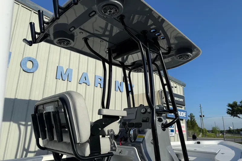 Slide: The Image of 2026 Blazer Bay PURE BAY 2200 boat with T-top and seating, docked at a marina. - 6