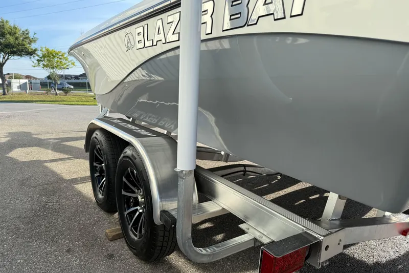 Slide: The Image of 2026 Blazer Bay PURE BAY 2200 boat on trailer, showcasing sleek design and dual wheels. - 9