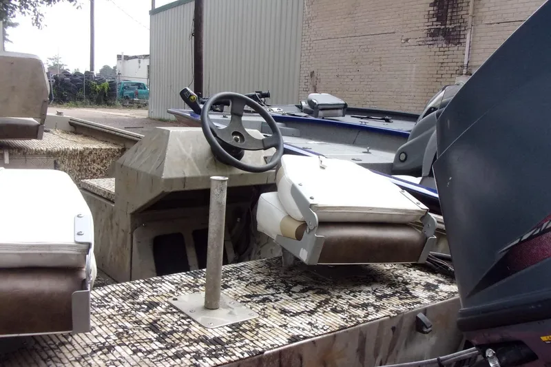 Slide: The Image of 2001 Xpress 1650VJF boat interior with steering wheel and seating. - 3