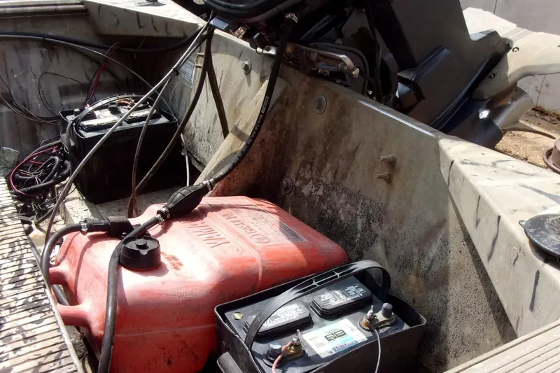 Slide: The Image of Interior of a 2001 Xpress 1650VJF boat showing fuel tank and battery setup. - 5