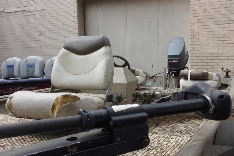 Slide: The Image of 2001 Xpress 1650VJF boat with worn seats and Yamaha 60 outboard motor. - 7
