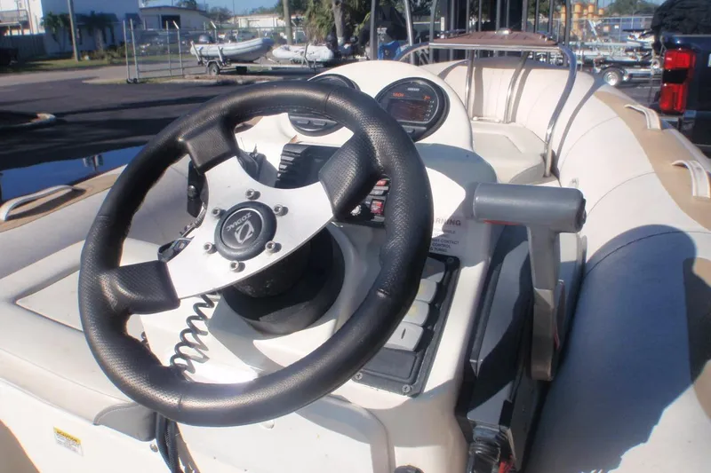 Slide: The Image of Steering console of a 2014 Zodiac Yachtline 420 boat, featuring a sleek design. - 2
