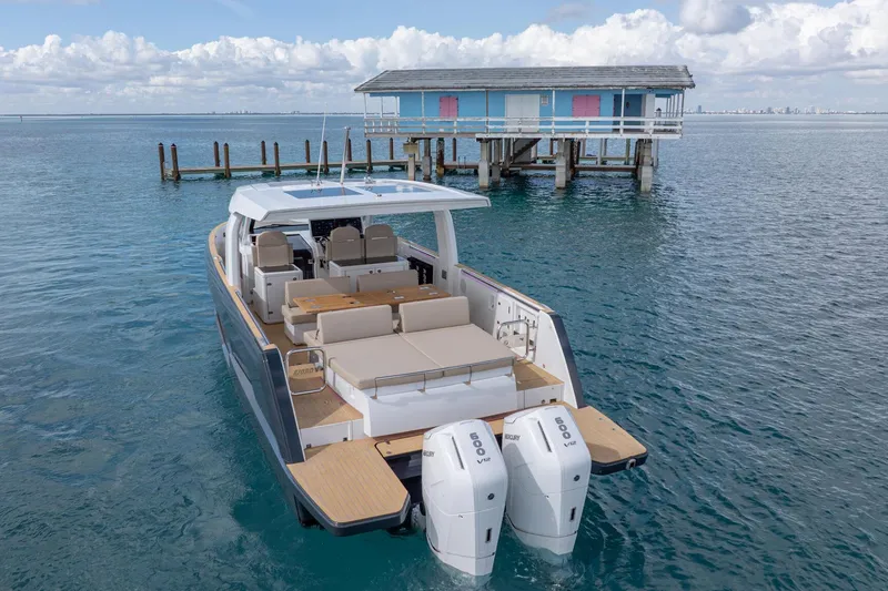 Slide: The Image of 2026 Fjord 41 XP boat near a stilt house on calm blue water. - 10