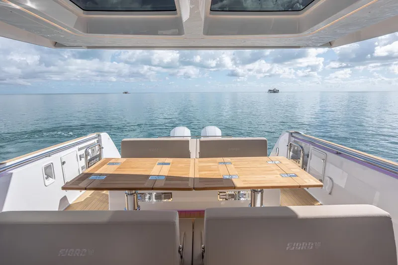 Slide: The Image of Luxury deck view of 2026 Fjord 41 XP yacht on calm ocean waters. - 17