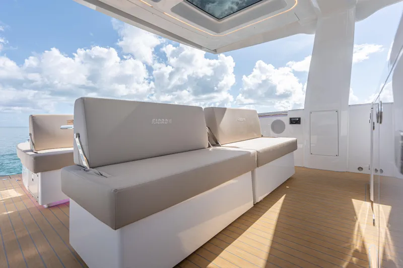 Slide: The Image of Luxurious seating on the 2026 Fjord 41 XP yacht, under a clear sky. - 19
