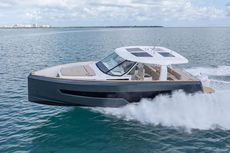 Slide: The Image of 2026 Fjord 41 XP yacht cruising on open water under a cloudy sky. - 2