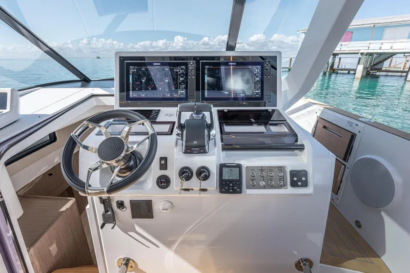 Slide: The Image of Cockpit of 2026 Fjord 41 XP yacht with advanced navigation displays and controls. - 21