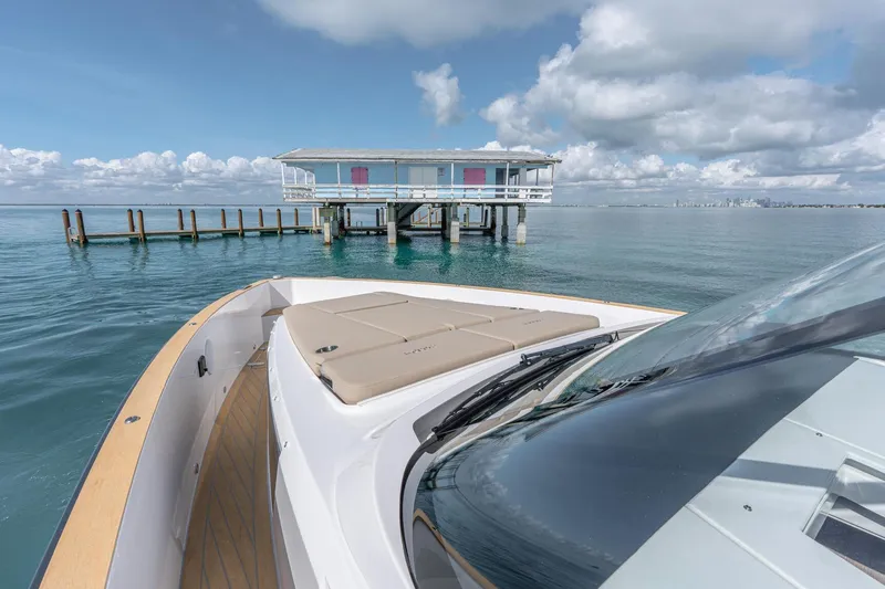 Slide: The Image of 2026 Fjord 41 XP yacht near a dock, under a partly cloudy sky. - 31