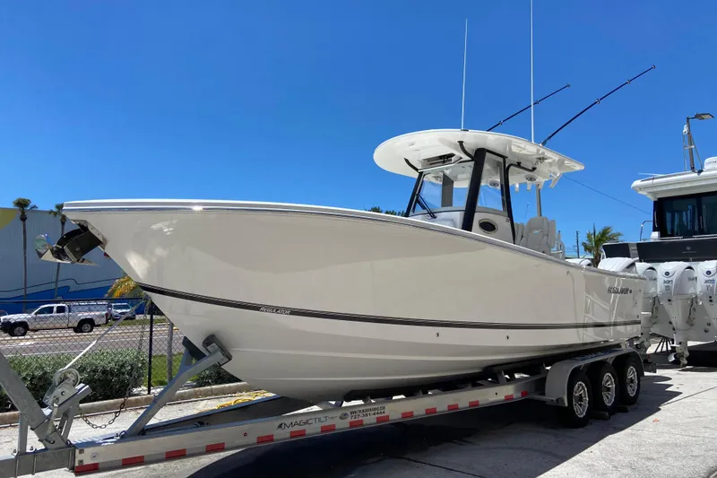 The Image of 2026 Regulator 28 boat on trailer under clear blue sky. - 0
