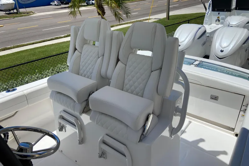 Slide: The Image of Luxury seating on a 2026 Regulator 28 boat, featuring plush, quilted white upholstery. - 10