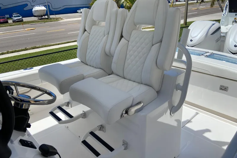 Slide: The Image of Luxury seating on 2026 Regulator 28 boat with dual Yamaha engines in background. - 11