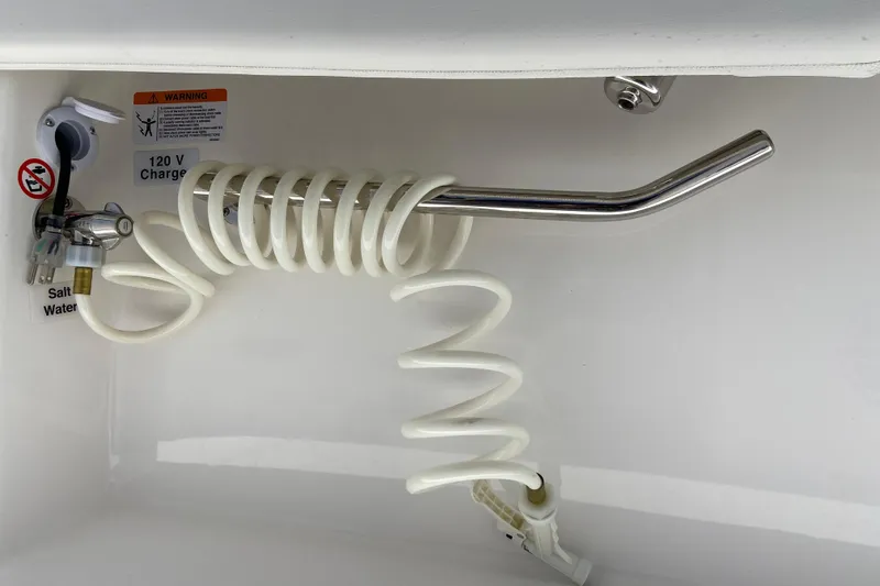Slide: The Image of Coiled hose and faucet in Regulator 28 boat, 2026 model, with 120V charger. - 12