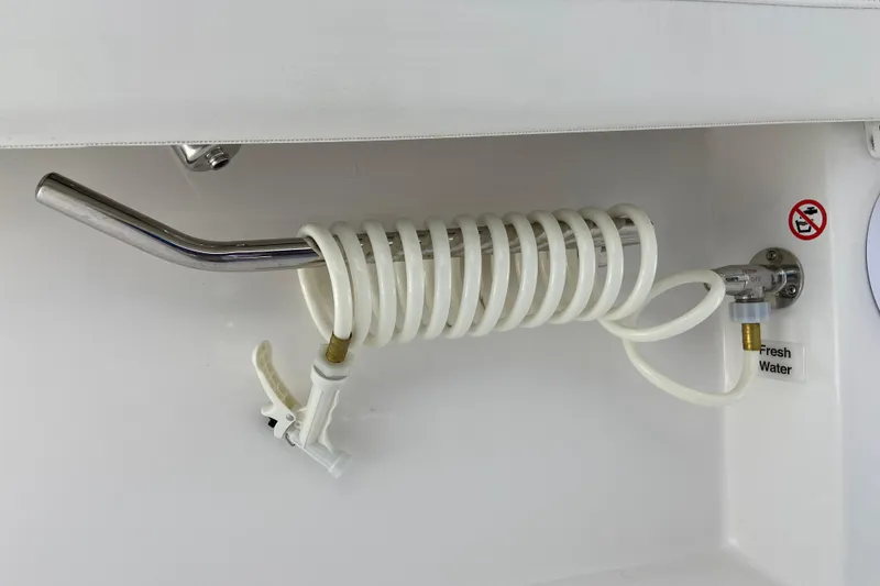Slide: The Image of Coiled hose and faucet in 2026 Regulator 28 boat, labeled "Fresh Water." - 13