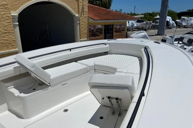 Slide: The Image of 2026 Regulator 28 boat with white cushioned seating and sleek design. - 14