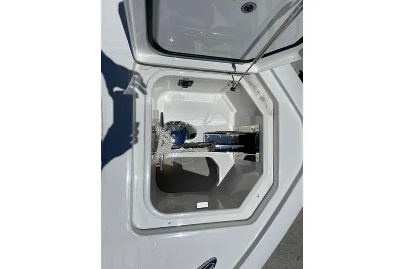Slide: The Image of Anchor storage compartment on 2026 Regulator 28 boat, featuring secure rope and hardware. - 18