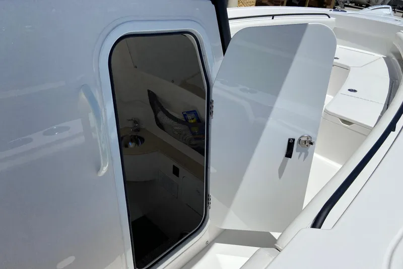 Slide: The Image of 2026 Regulator 28 boat cabin entrance with open door and interior view. - 21